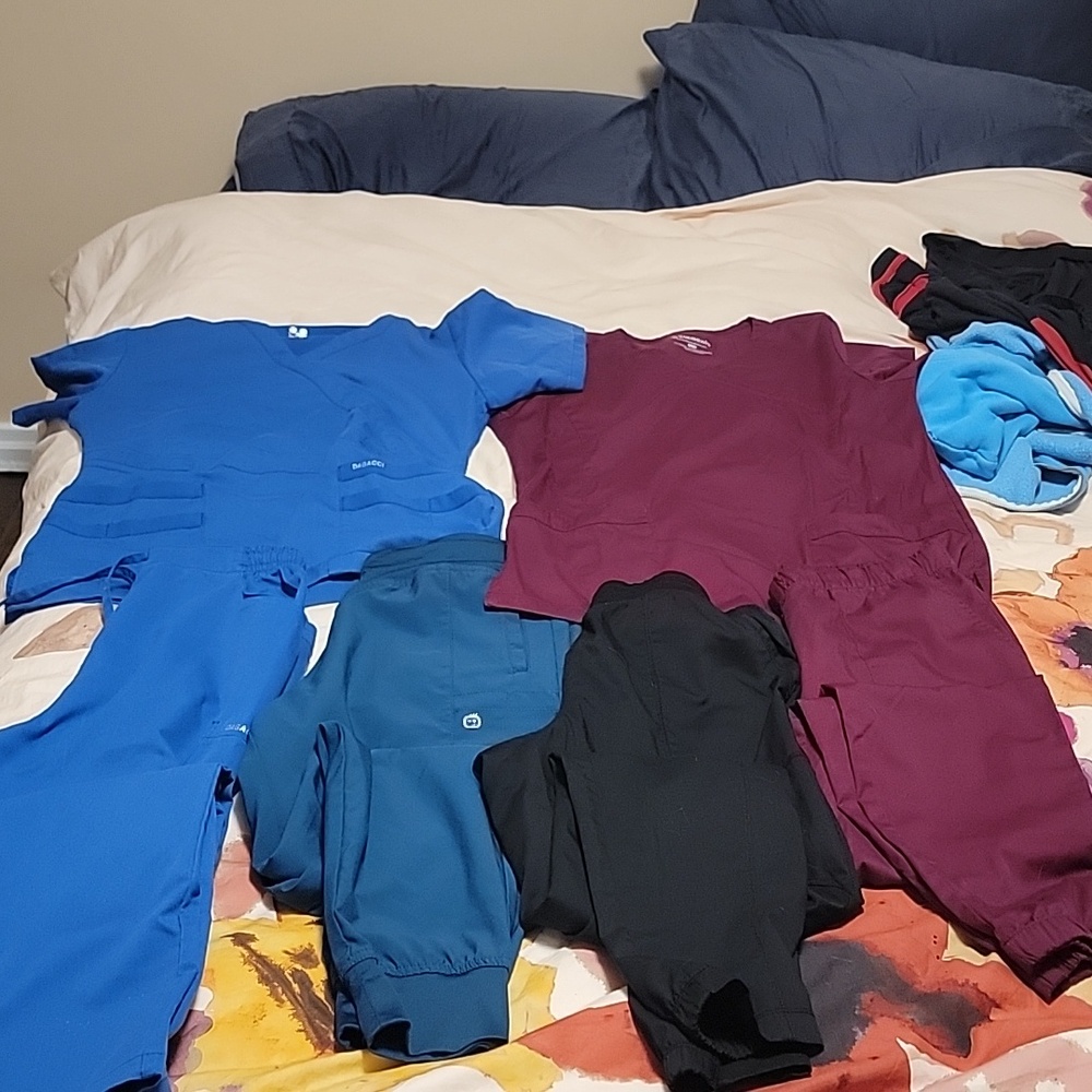Assorted scrub tops and bottoms